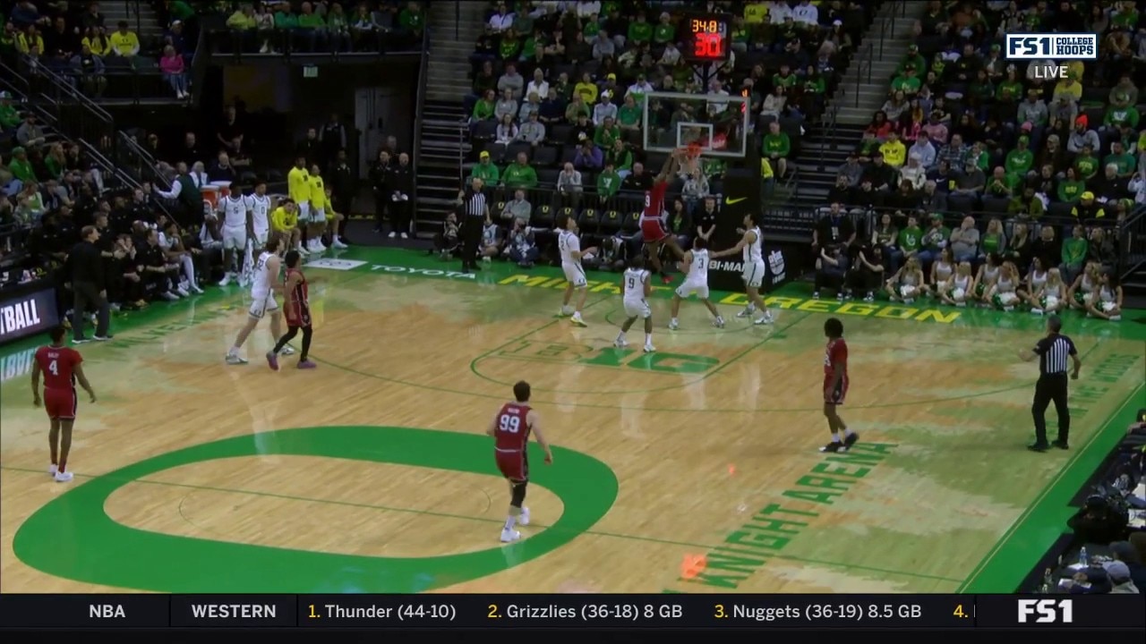 Rutgers' Dylan Grant gets UP to throw down a dunk, trimming the Oregon lead